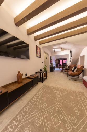 a living room with a rug on the floor at Casa Tonalli Boutique in Mexico City