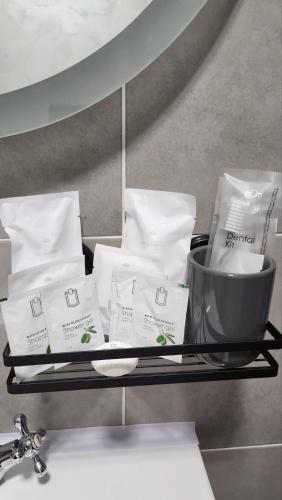 a shelf with white towels and a bowl on it at Crassula Lux 2 in Surčin