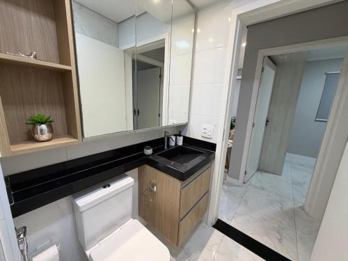 a bathroom with a sink and a mirror at Recanto das Colinas II in Espirito Santo Do Pinhal