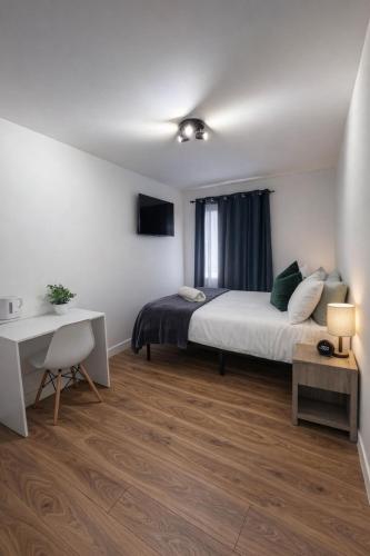 a bedroom with a bed and a desk and a desk at Mary House London in Edmonton