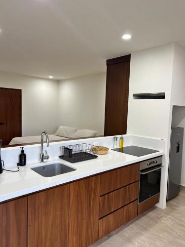 a kitchen with a sink and a stove at Modern studio in a waterfront building in Cozumel