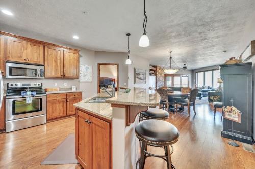 a kitchen with wooden cabinets and a dining room at Bridges Bay Resort Coronado building 200 in Arnolds Park