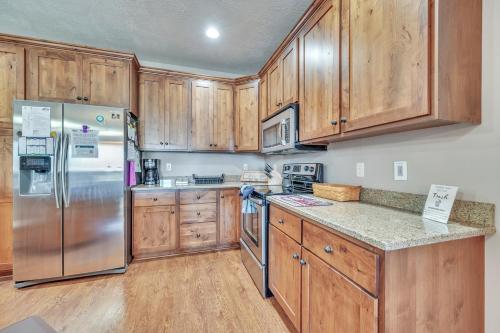 a kitchen with wooden cabinets and a stainless steel refrigerator at Bridges Bay Resort Coronado building 200 in Arnolds Park