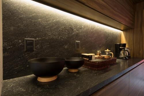 a bathroom with a black bowl on a counter at Casa Tonalli Boutique in Mexico City