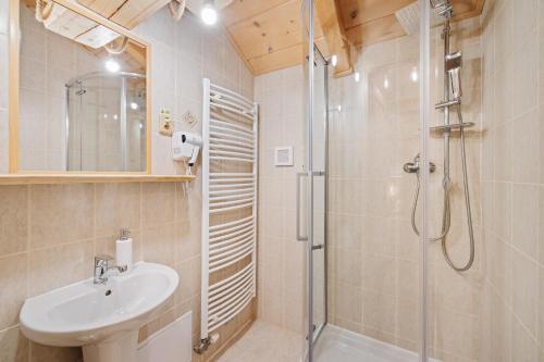 a bathroom with a shower and a sink at RANČ Podlesok Relax in Hrabušice