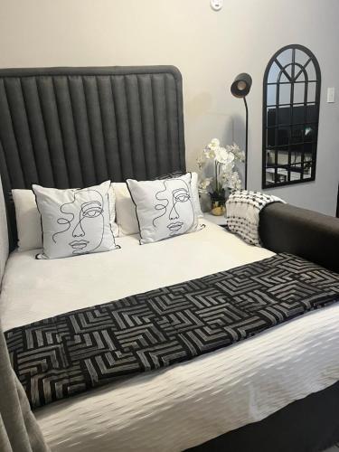 a bedroom with a large bed with white sheets and pillows at B-Hive at Devland Room 3 in Soweto