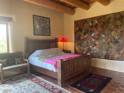 a bedroom with a bed and a chair in a room at "Crows Nest" at Winsor Castle in Valdez
