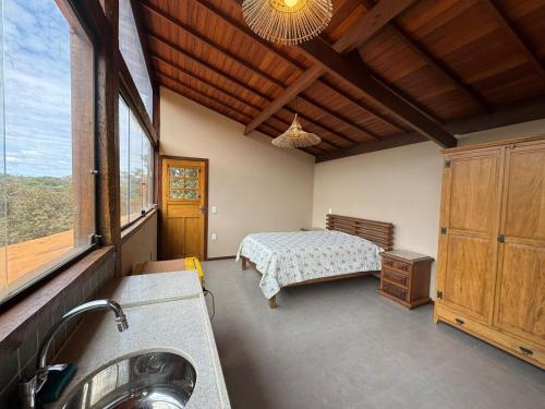 a bathroom with a bed and a sink in a room at CASA VENTO SOLAR in Santana do Riacho