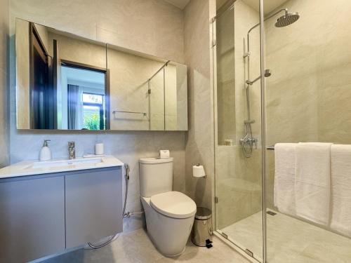 a bathroom with a toilet and a sink and a shower at Lovely 2 Bdr Canvas BangTao in Laguna Phuket