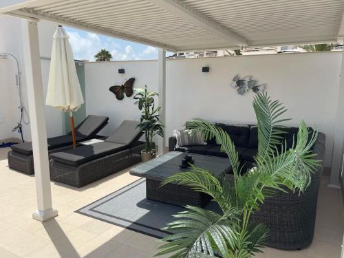 a living room with a couch and a table at Penthouse Mojacar beach newly build in Mojácar