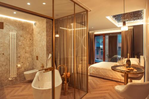 a bathroom with a bed and a tub and a sink at Gdańsk Luxury Stay Jacuzzi in Gdańsk