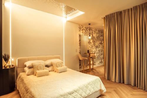 a bedroom with a bed with white sheets and pillows at Gdańsk Luxury Stay Jacuzzi in Gdańsk