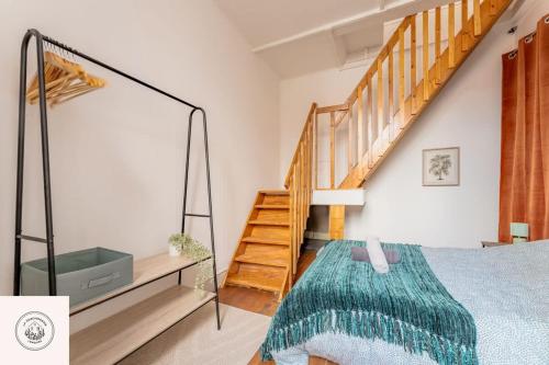 a bedroom with a bed and a staircase at Cosy flat, Duplex, proche centre ville in Lens