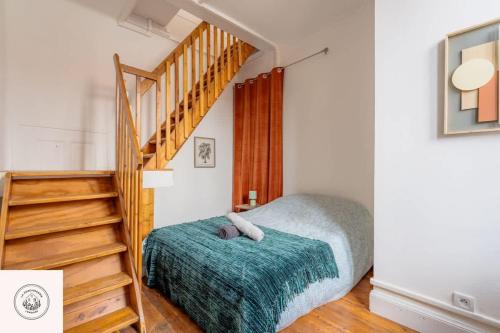 a bedroom with a bed and a stair case at Cosy flat, Duplex, proche centre ville in Lens
