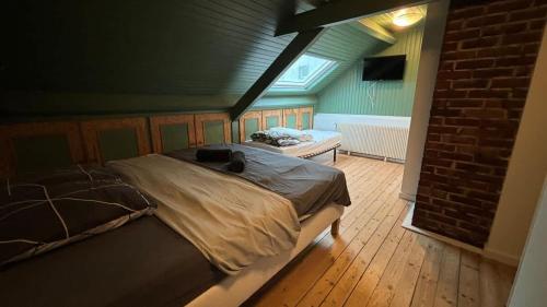 a bedroom with a large bed in a room at Grande Maison 17 personnes in Arras