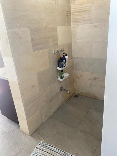 a bathroom with a shower with a sink and a shower at Casa Kimara in Uvita