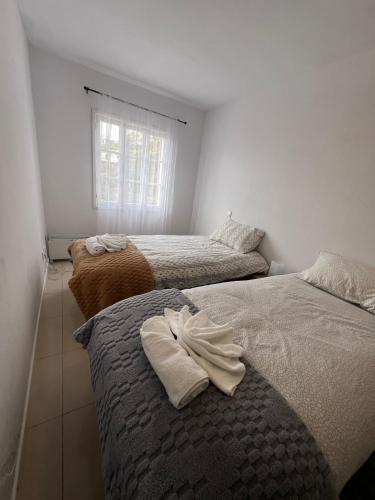 a bedroom with two beds with towels on them at Latin House in Funchal
