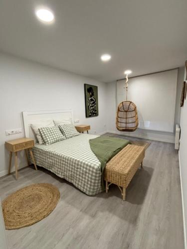 a bedroom with a bed and a table and a rug at Marea in Sanxenxo