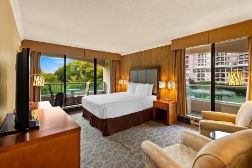 a hotel room with a bed and a balcony at Best Western PLUS Inner Harbour Hotel in Victoria