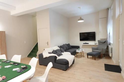 a living room with a couch and a table at L'As d'Aubert - 8 pers - Centre in Arras