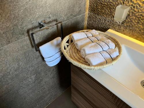a bathroom with a basket of towels on a sink at Duplex Villa 4 rooms in Marsa Matruh