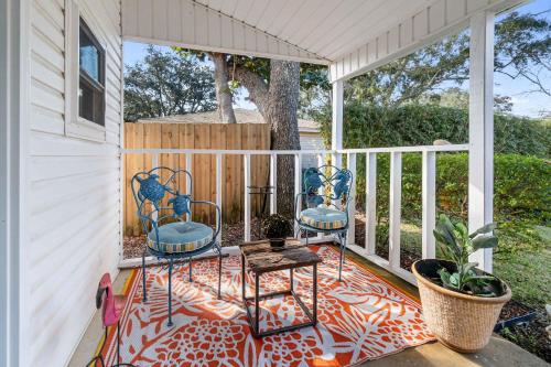 two chairs and a table on a porch at Beach Barn - 5min to Pcola Beach , Full Kitchen in Gulf Breeze