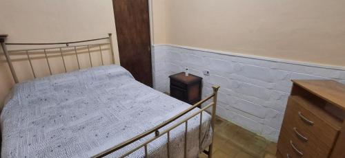 a bedroom with a bed and a wooden dresser at El limonero in Paso de los Libres