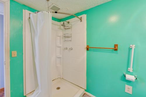 a bathroom with a shower with a white shower curtain at Lake Views + Dock Access: Georgetown Group Getaway in Georgetown