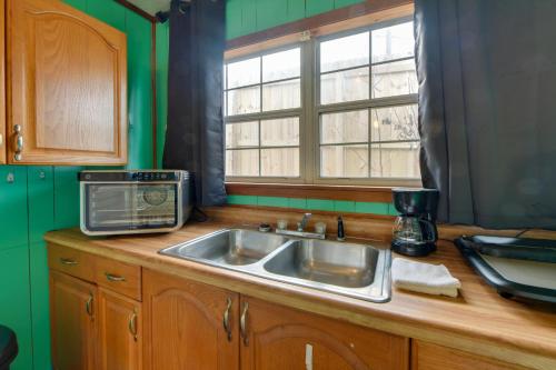 a kitchen with a sink and a microwave on a counter at Couple’s Retreat w/ Dock Access on Lake Eufaula! in Georgetown