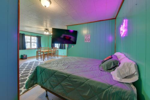 a bedroom with a bed and a flat screen tv at Couple’s Retreat w/ Dock Access on Lake Eufaula! in Georgetown