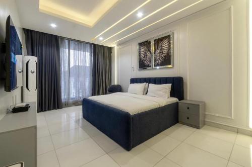 a bedroom with a bed and a large window at Olaz holmes in Lagos