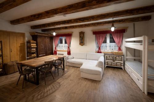 a living room with a couch and a table and a bunk bed at Chata Porcelánka in Desná