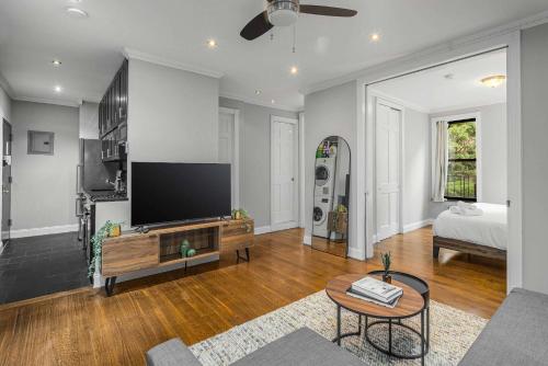 a living room with a flat screen tv on a wall at Modern Manhattan Retreat Near Central Park in New York