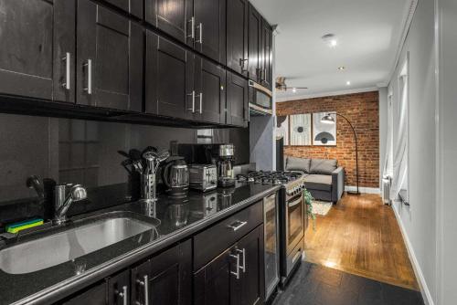 a kitchen with a sink and a counter top at Modern Manhattan Retreat Near Central Park in New York