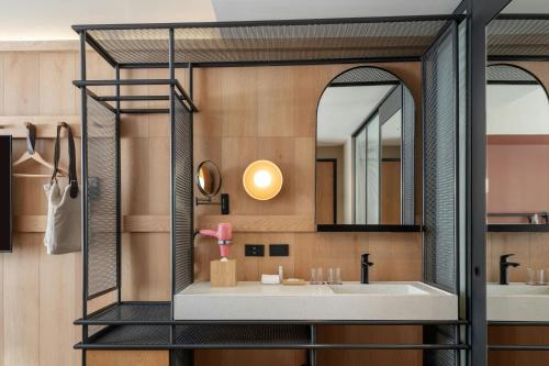 a bathroom with a sink and a mirror at Moxy Tulum in Tulum