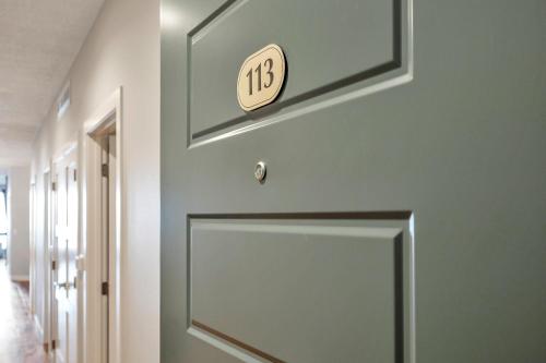 a door in a hallway with a clock on the wall at Stillwater 113 in Arnolds Park