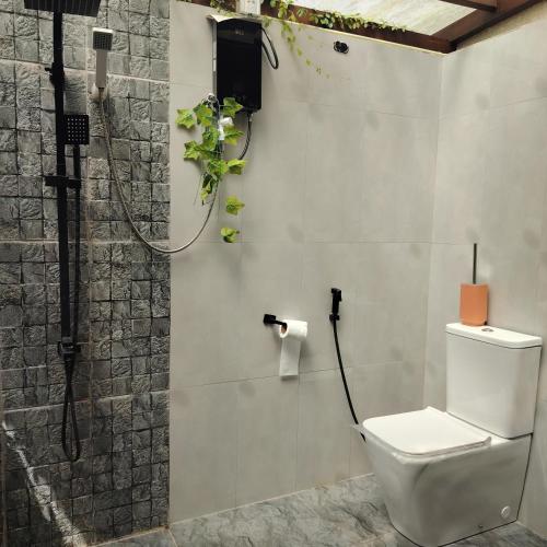a bathroom with a toilet and a shower at Hideout Galle in Galle