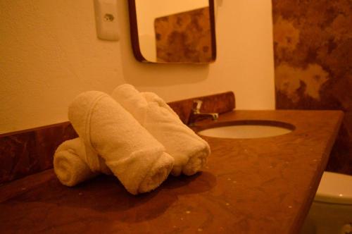 a towel laying on a counter in a bathroom at Casarão Duque do Mel in João Pessoa