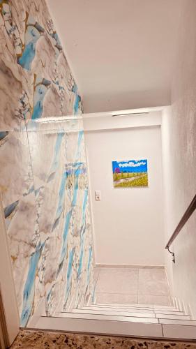 a hallway with a marble wall with a painting on it at Emily’s Apartment in Blaustein