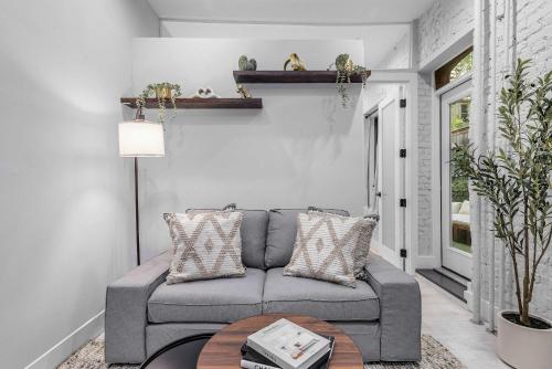 a living room with a couch and a table at Modern Nolita Hideaway in New York