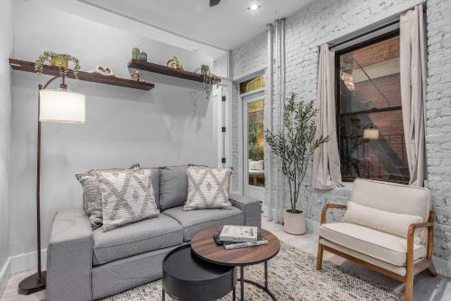 a living room with a couch and a table at Modern Nolita Hideaway in New York