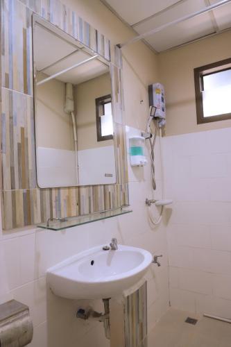 a bathroom with a sink and a mirror at TC House and Cafe in Chiang Mai