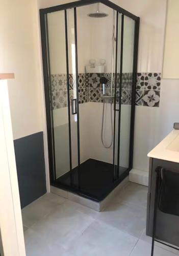 a shower with a glass enclosure in a bathroom at Gîte Ruoms in Ruoms