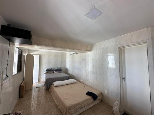 a bedroom with two beds and a window and a door at Casa Beira Mar lha de Itamaracá in Itamaracá