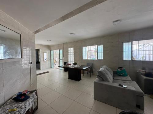 a living room with a couch and a table at Casa Beira Mar lha de Itamaracá in Itamaracá
