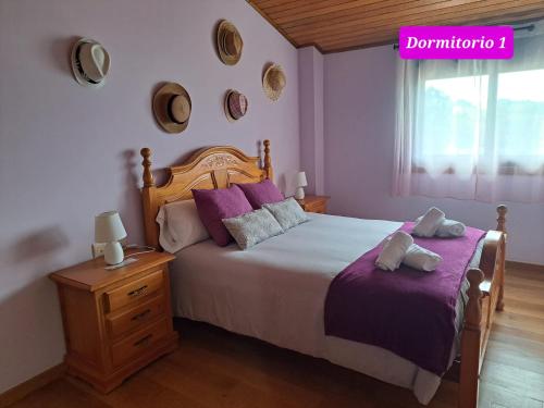 a bedroom with a large bed with purple pillows at Ultreia in Arcade