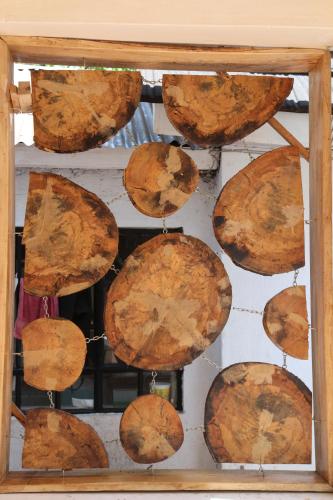 a bunch of logs hanging on a wall at Sahara Gardens-Kericho in Kericho