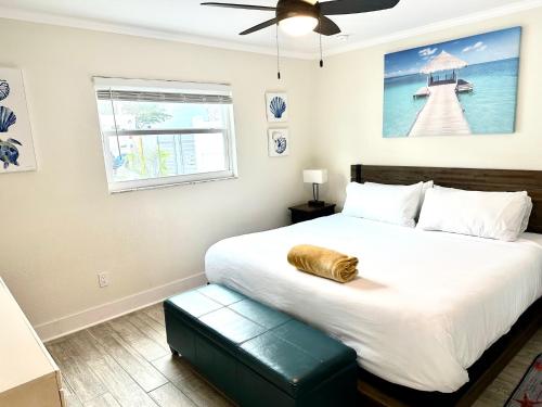 a bedroom with a large bed with a pillow on it at Sunset by the Sea 3054 in Fort Myers Beach