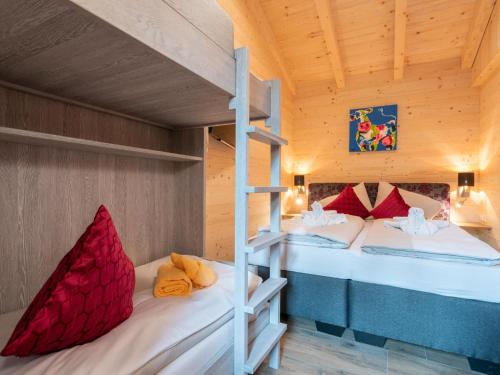 two bunk beds in a room with a ladder at Adventure Lodge Kaprun in Kaprun