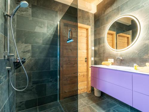 a bathroom with a shower and a sink and a mirror at Adventure Lodge Kaprun in Kaprun